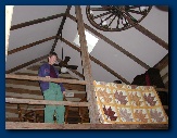 Bev in loft with handmade quilt